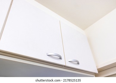 Clean White Storage Shelves Near The Ceiling