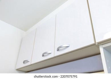 Clean White Storage Shelves Near The Ceiling