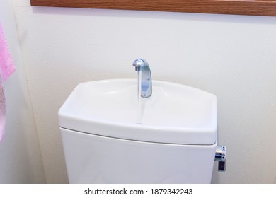 Clean white tank of flush toilet