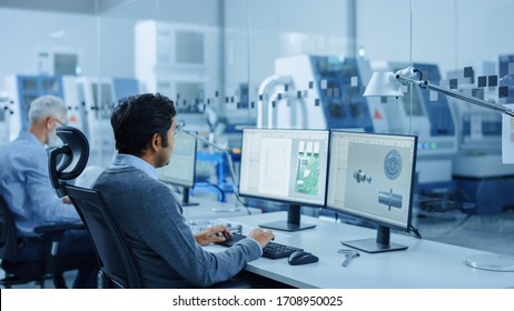 In Clean Workshop: Professional Workers in Coveralls and Masks Use Laptop and Talk. Inside Factory Office: Female Electronics Engineer Works on Computer, Screen Shows Printed Circuit Board 3D Design - Powered by Shutterstock