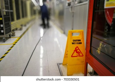 The Cleaner Cleaning Industrial Floor. Be Careful Of Slippery Floor.