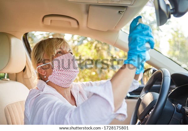 Cleaner with face mask\
cleans and disinfects rear-view mirrors in rental cars due to\
coronavirus pandemic