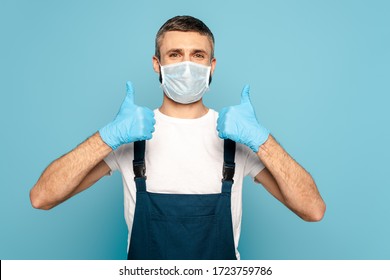 Cleaner In Medical Mask Showing Thumbs Up On Blue Background