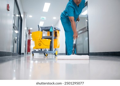 Cleaner using mops, cleaner with mop and uniform cleaning hall floor, hospital cleaning floor with mop in patient room the hospital epoxy floor