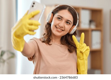 Cleaner woman, selfie and peace sign with smile, headphones and audio streaming for music in home. Happy maid girl, emoji or icon with photography, memory and profile picture on social network app - Shutterstock ID 2364786683