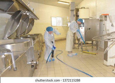 cleaners cleaning industrial kitchen floor