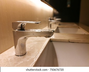 Cleaning Bathroom Sink In Public Restroom