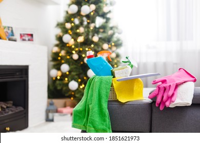 Cleaning before Christmas. Multicolored cleaning supplies. Sponges, rags and spray with festive decorations against modern home background - Powered by Shutterstock