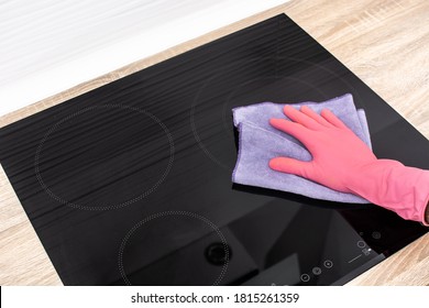 Cleaning A Black Electric Induction Cooktop.Close Up