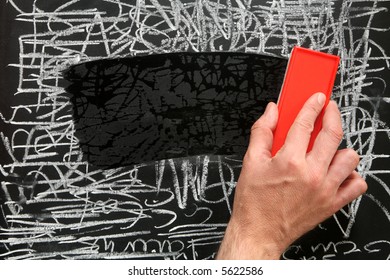 Cleaning A Blackboard With A Red Chalk Duster.