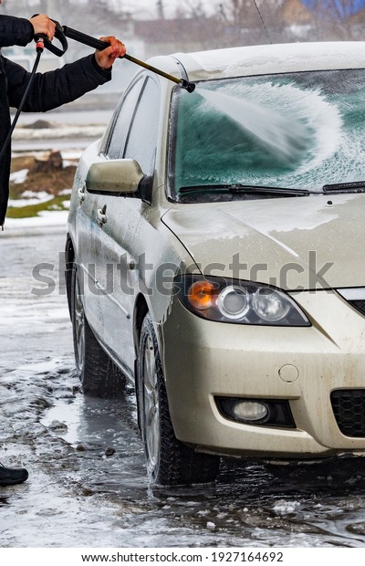 Cleaning the car, car care concept.\
car wash with water and foam cleaning. auto, service\
vehicle