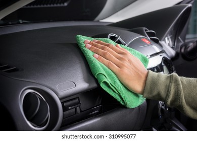 Cleaning The Car Console With Microfiber Cloth