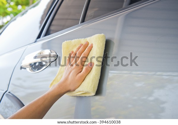 Cleaning\
the car door from dirt with fabric ,and\
waxing
