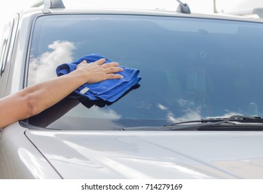 Cleaning The Car Glass With Microfiber Cloth