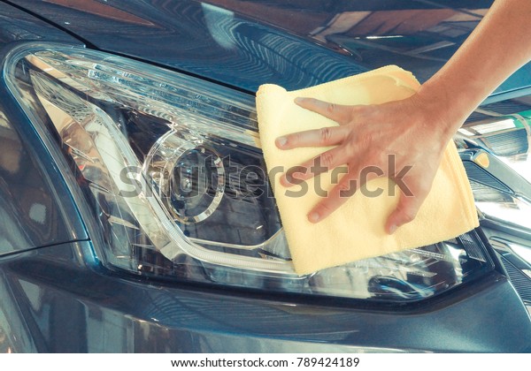 Cleaning car\
headlight with micro fiber\
cloth