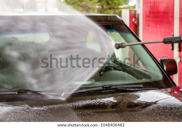 Cleaning car with high\
pressure water