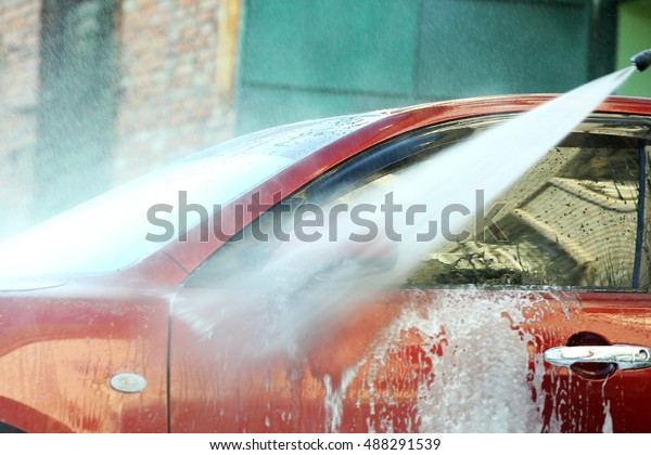 Cleaning car with high\
pressure water