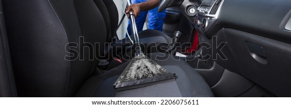 Cleaning Car\
Interior. African Worker Washing\
Auto