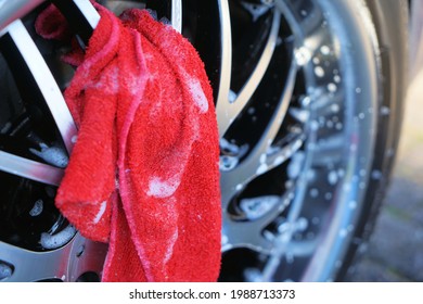 Cleaning Car Rims Using A Red Cloth