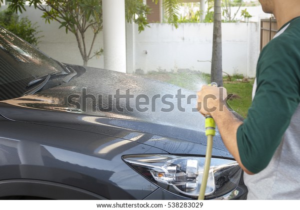 Cleaning Car Using High\
Pressure Water.