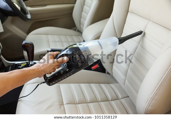 Cleaning a car using a\
vacuum cleaner