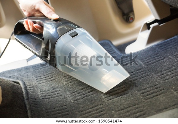 Cleaning a car using a\
vacuum cleaner