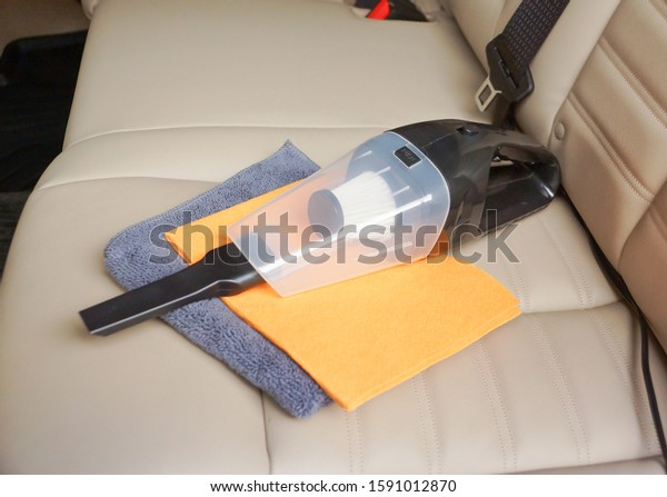 Cleaning a\
car using a vacuum cleaner and chamois\
cloth