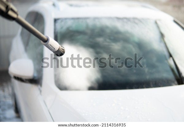 Cleaning Car Using Washing with soap. High Pressure\
Water. Manual car wash with white soap, foam on the body. Manual\
car wash outside. Close\
up.