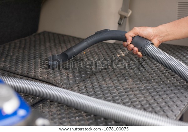 Cleaning a car with vacuum\
cleaner