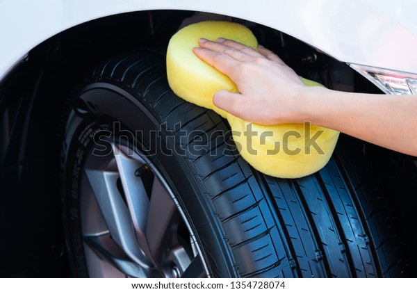 Cleaning car wheel, wiping tire after cleaning
on car washing.