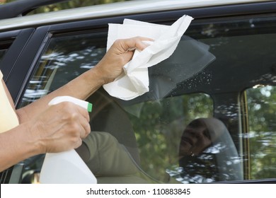 Cleaning The Car Window With Paper Towel, Close Up