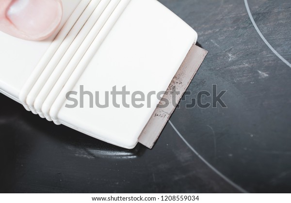 Cleaning Ceramic Glass Cooktop Glass Scraper Stock Image