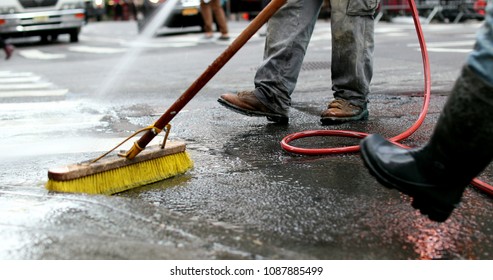 Cleaning city streets with water hose