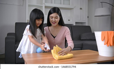 Cleaning Concept. Mother And Daughter Help With Cleaning The House.