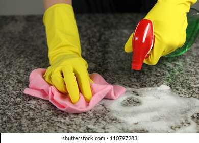 Cleaning A Counter Top With A Special Spray