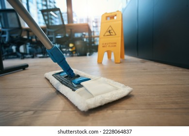 Cleaning coworking space with special mop, next to folding stepladder - Shutterstock ID 2228064837