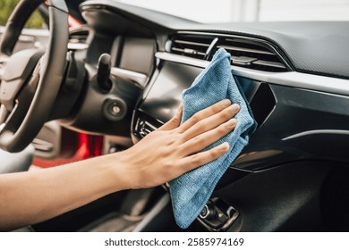 Cleaning and detailing car interior using microfiber towel