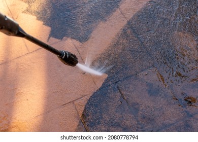 Cleaning Dirty Backyard Paving Tiles With Pressure Washer Cleaner. Spring Clean Up