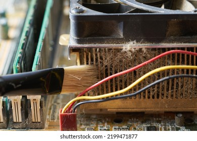 Cleaning Dirty Desktop Computer Processor Fan From Dust By Special Brush Close Up.