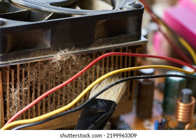 Cleaning Dirty Desktop Computer Processor Fan From Dust By Special Brush Close Up.