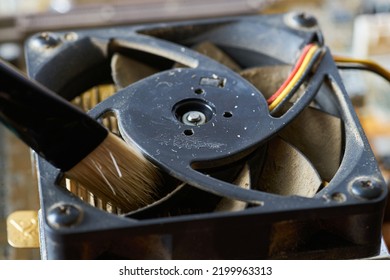 Cleaning Dirty Desktop Computer Processor Fan From Dust By Special Brush Close Up.