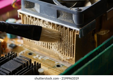 Cleaning Dirty Desktop Computer Processor Fan From Dust By Special Brush Close Up.