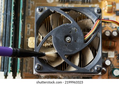 Cleaning Dirty Desktop Computer Processor Fan From Dust By Special Brush Close Up.