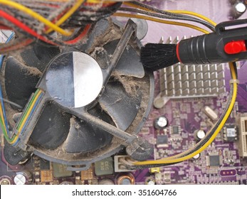 Cleaning Dirty Desktop Computer Processor Fan From Dust By Special Brush Close Up.