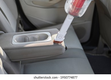 Cleaning Dirty Vehicles Interior Uses Wireless Vacuum Cleaner. Cleans The Light Cloth Interior Of The Car. Spring Dry Automobile. Car Care Work. Helpful Device For Cleaning Dust.