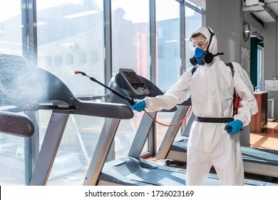 Cleaning and Disinfection in crowded places amid the coronavirus epidemic Gym cleaning and disinfection Infection prevention and control of epidemic. Protective suit and mask and spray bag - Shutterstock ID 1726023169