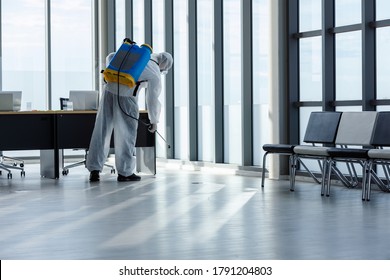 Cleaning And Disinfection At Office Amid The Coronavirus Epidemic Professional Teams For Disinfection Efforts Infection Prevention And Control Of Epidemic Protective Suit And Mask.