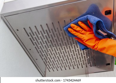 Cleaning Domestic Cooker Hood. Women's Hands Clean The Kitchen Hood With A Cloth