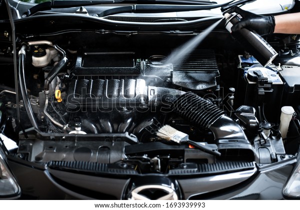 Cleaning the engine bay. Car cleaning and car\
detailing concept.