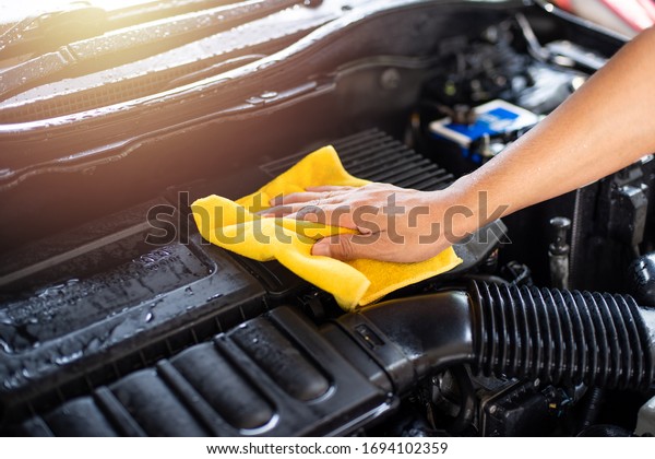 Cleaning the engine bay. Car cleaning and car\
detailing concept.